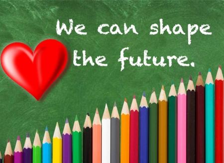 A graphic of a chalboard with a heart and writing that reads "We can shape the future." Colored pencils stack below. 