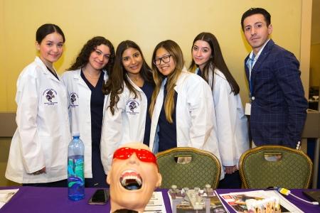 Dental program students from Totten-ville HS on Staten Island are dressed to drill as they pose with their teacher, Joseph Caputo.