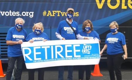 Group of activist stand in front of AFT truck 