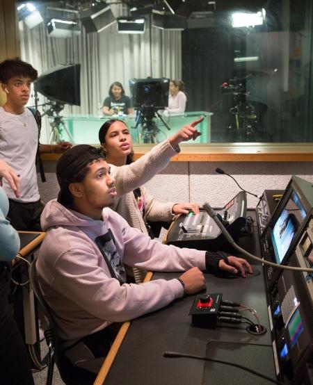 Students in the control room manage the recording.