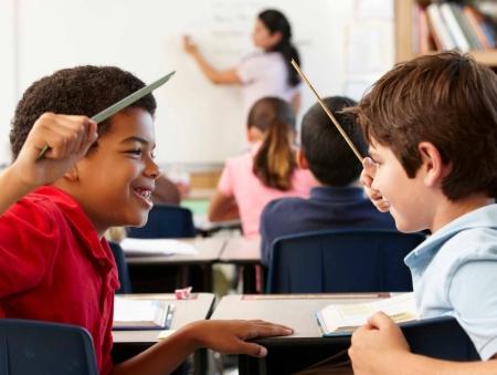 Two boys playing in class