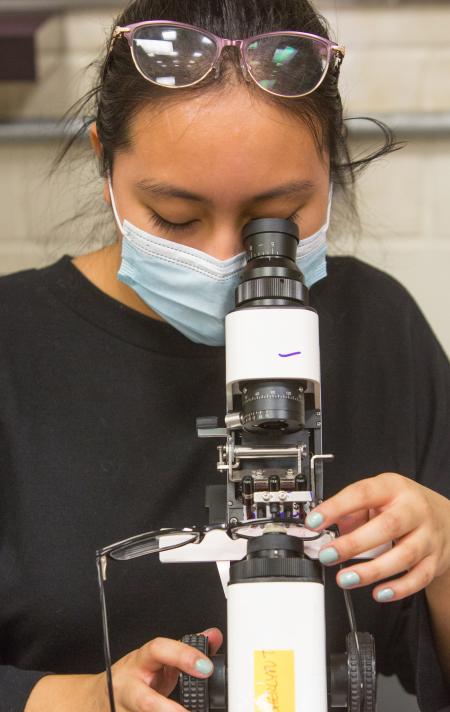 Woman looking through a lensometer