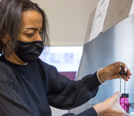 Woman adding tint to eyeglass lens