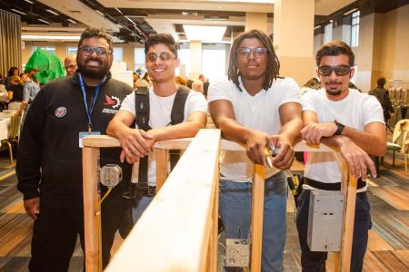 HS for Construction Trades, Engineering and Architecture teacher Mohammed Hossain (left) and his students at the Queens school display their engineering talents.