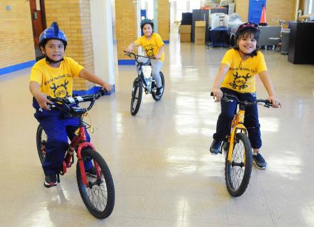 Three kids riding bikes