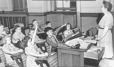 A teacher teaching kids kids in 1962