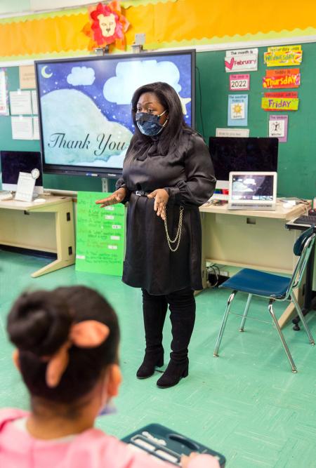 Teacher Tiali Kyte gives students a recap of the event.