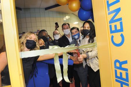 Sharing the duties at the opening of the Teacher Center at PS/IS 266 in Bellerose, Queens, are Chapter Leader Jennifer Bianco (left), Principal Ayanna Greenidge (second left) and  site coach Liza Reyes (right).