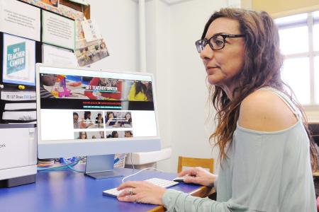 Teacher Stacey Schwartz uses one of the computers in the new Teacher Center at PS 107 in East Flushing, Queens.