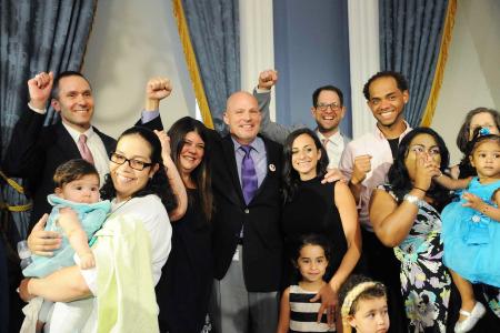 Members cheer for paid parental leave.