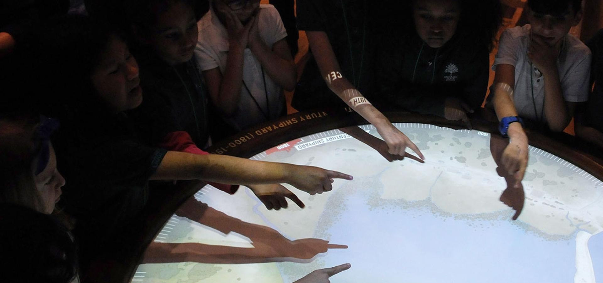 As if by magic, students put their hands over an area on this interactive map of