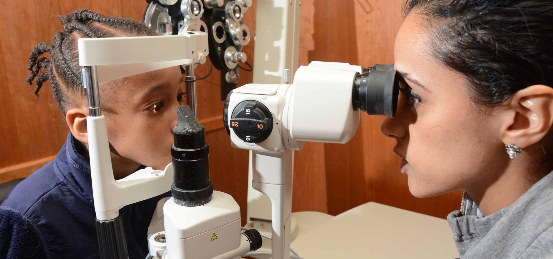 Girl being examined by eye doctor