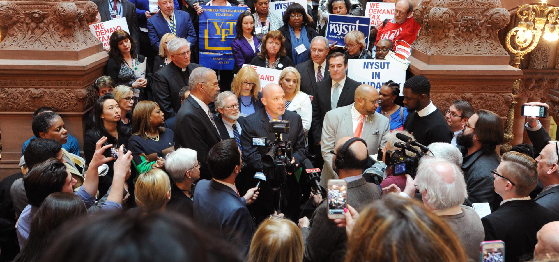 UFT President Michael Mulgrew surrounded by news reporters