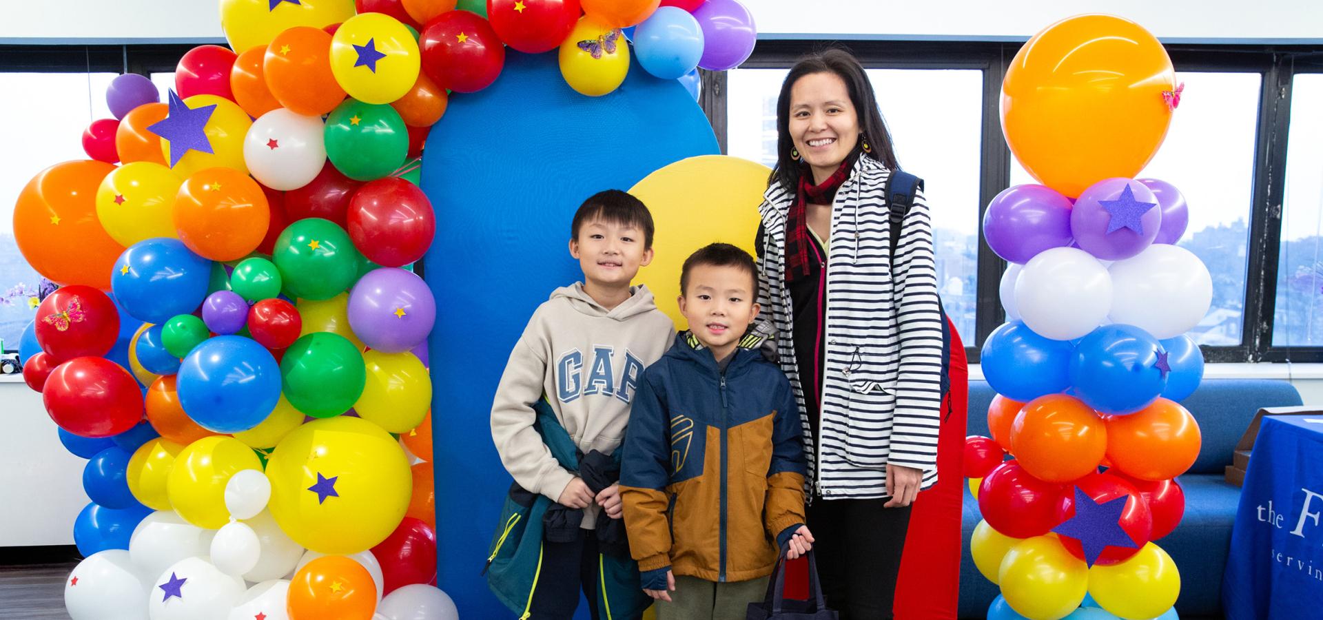 A parent with her two children at a UFT Parent Conference. 