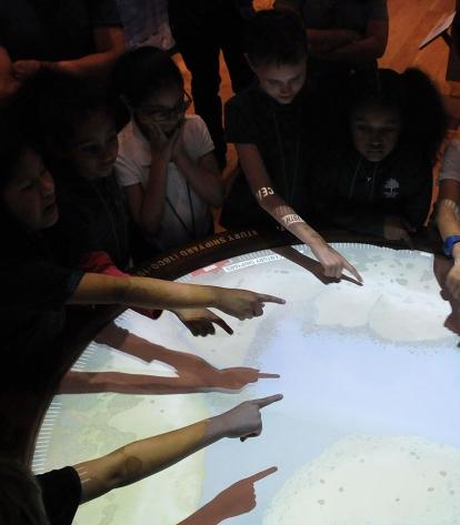 As if by magic, students put their hands over an area on this interactive map of