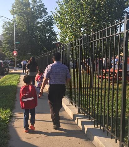 A father and son head off to school at PS 303 in Forest Hills, Queens.