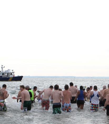Adventurous New Yorkers frolic in the ocean off Coney Island.