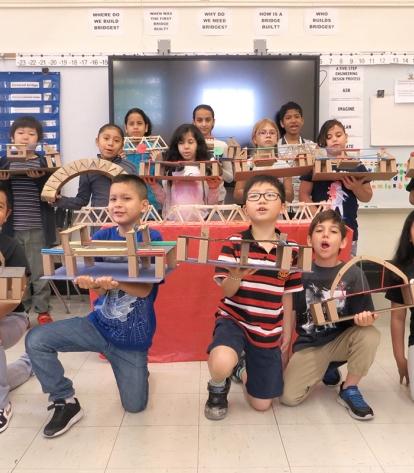 The students show off their working models.