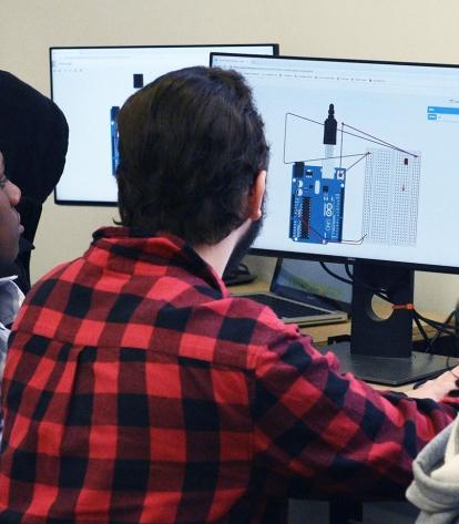 Two students work on a circuit.