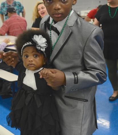 Looking sharp, Omari and his 17-month-old sister survey the dancers.