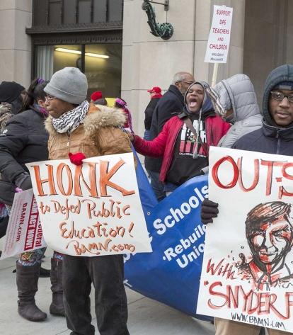Detroit public school teachers rally in January outside a Michigan courthouse to
