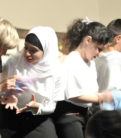 Students “wash” pajamas on the factory assembly line.