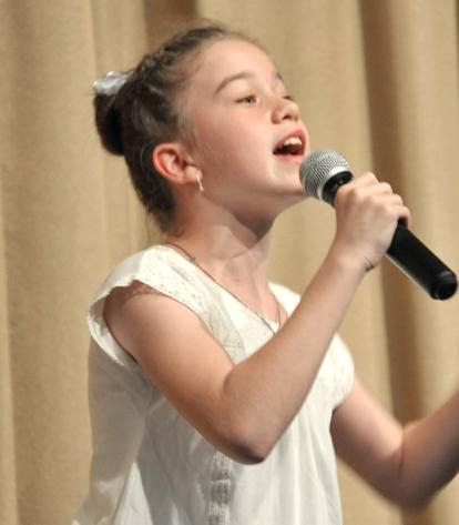 One 5th-grader with an outstanding voice sings a solo.