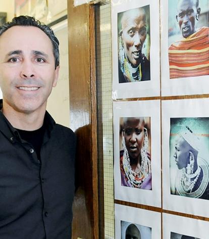 Raphael Lopez, shown here with his photographs of the Maasai people in Kenya, of