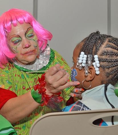 A child has her face painted.