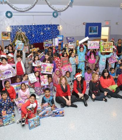 Students at PS 65 show off their gifts, with staff and UFT volunteers.