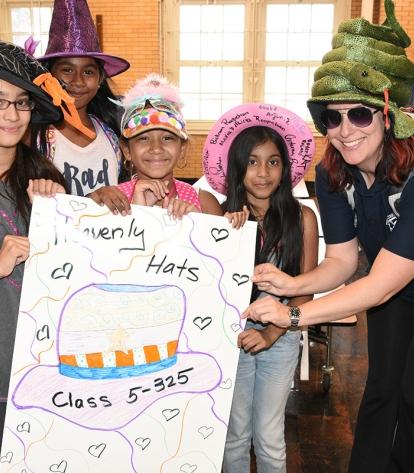 Teacher Rachel Mansdorf and her 5th-grade students show off their colorful hats.