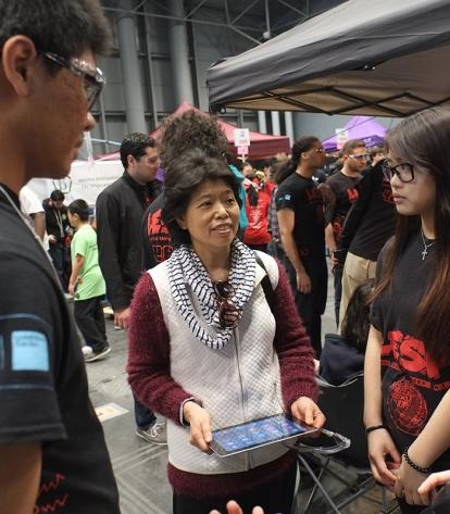 Chapter Leader Paula Chen (center) says the robotics program gives English langu