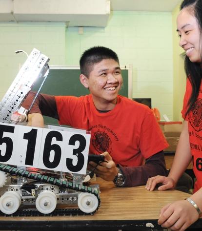 Two of the team members and the Flying Dragons’ award winning small robot.