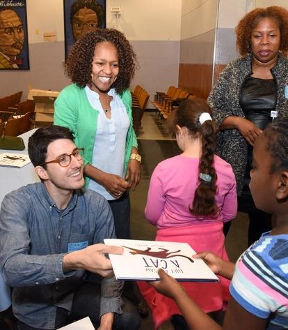 Author-illustrator Brendan Wenzel gives autographed copies of his book — “They A