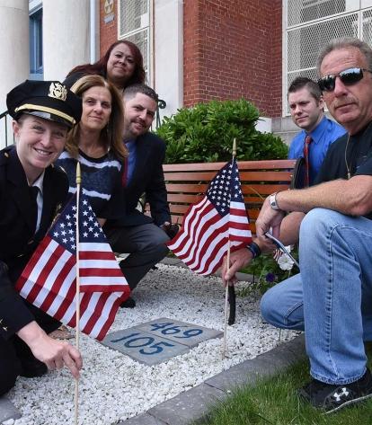 Setting American flags in front of the bench named for Detective Moore are (from