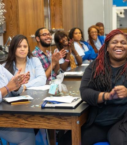 School staff applaud the proceedings.