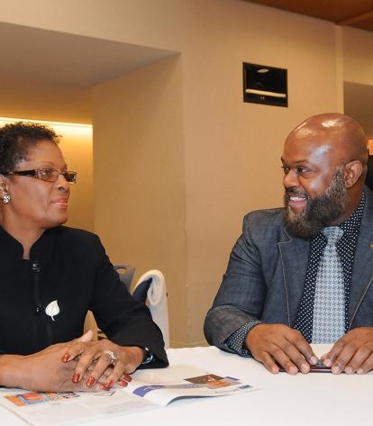 UFT staffer Sean Blanks talks to the Rev. Patricia Malcolm, with Churches United