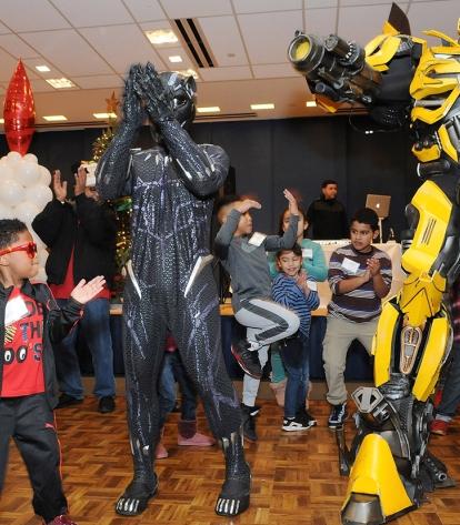  Partygoers mix it up with the Black Panther and Bumble Bee Transformer.