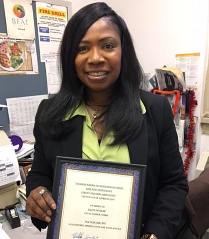 School nurse Allita Paul-Aguilar receives a PTA certificate of appreciation.