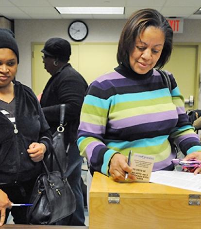 Susan Campbell, a provider in Brooklyn, casts her vote on the new contract.