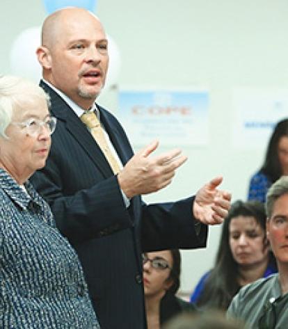Chancellor Carmen Fariña (standing, second from left) and UFT President Michael 