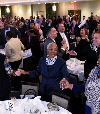 UFT members join hands and sing the union anthem “Solidarity Forever” to close o