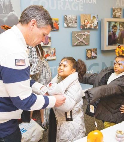 Young partygoers line up to try on their new jackets 