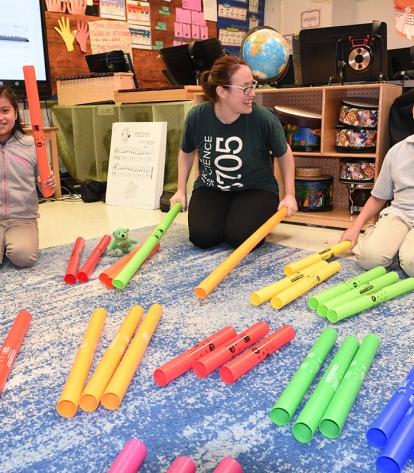 Music teacher Elana Master plays boomwacker instruments with her students.