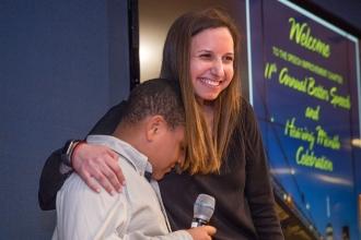 Student Nickolas gets a hug from speech teacher Tracey Olesh of PS 94 at PS 361,
