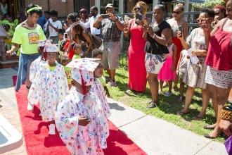 The children walk down the red carpet to the delight of parents and guests.