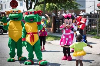 One of the youngsters runs into the arms of Minnie Mouse as a pair of Ninja Turt