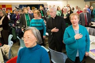 Attendees say the Pledge of Allegiance before the festivities begin.