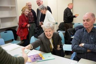 Ann Garvey, a retired teacher from District 26, buys a raffle ticket.