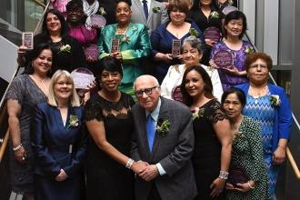 The honorees line up for a group shot behind UFT Family Child Care Providers Cha